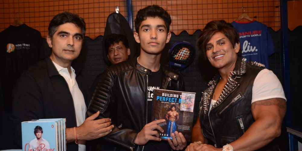 Yash Birla Standing On Right With Young Boy Who Is Holding Book